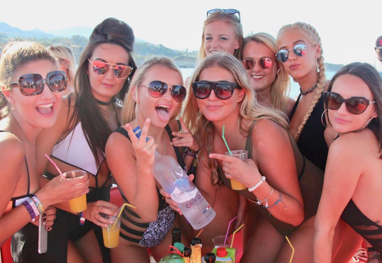 Friends crowding together for a photo on the yacht deck